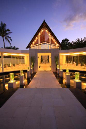a building with lights in front of it at night at The Kunja Villa-Hotel in Seminyak
