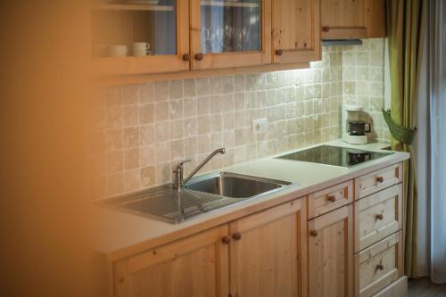 a kitchen with a sink and a counter top at Appartement & Hotel Innerhofer in Gais