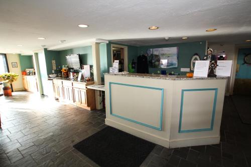 a store with a counter with blue doors in a room at Ocean Club on Smuggler's Beach in South Yarmouth