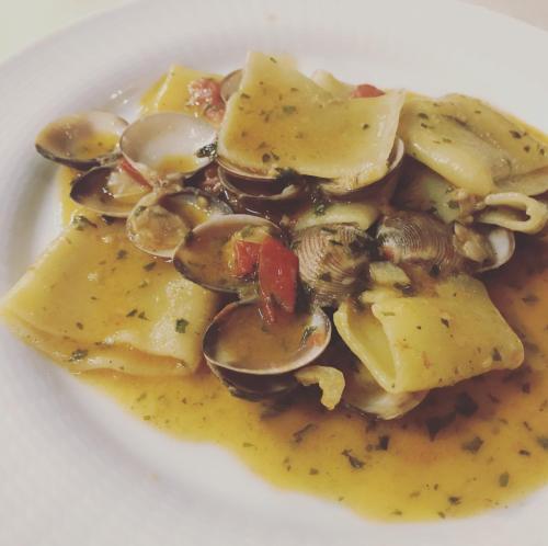 a white plate of food with mushrooms and sauce at Hotel La Fattoria Sul Mare in Capo Vaticano