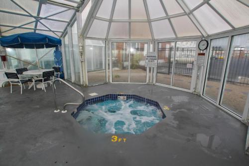 a hot tub in a tent with a table and chairs at Ocean Club on Smuggler's Beach in South Yarmouth