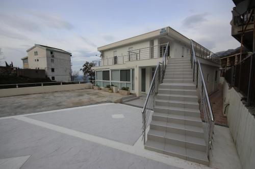 a building with stairs in front of it at Vila Nikezić in Sutomore