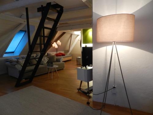 a living room with a loft bed and a lamp at Blue Wall BnB in Gebenstorf