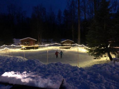 two people skiing in the snow at night at Hope Alaska's Bear Creek Lodge in Hope