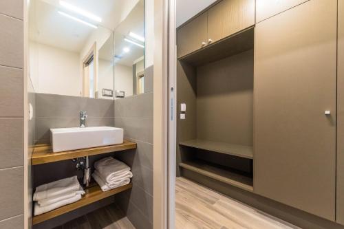 a bathroom with a sink and a mirror at parina Inn – Locanda in Camerata Cornello