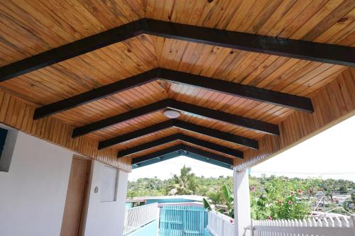 a wooden pergola with a wooden roof at Holiday Hire Fiji in Lautoka