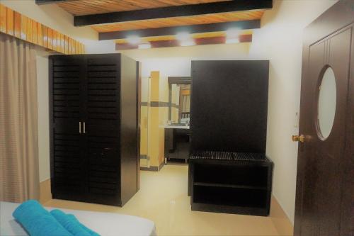 a room with a black door and a mirror at Holiday Hire Fiji in Lautoka