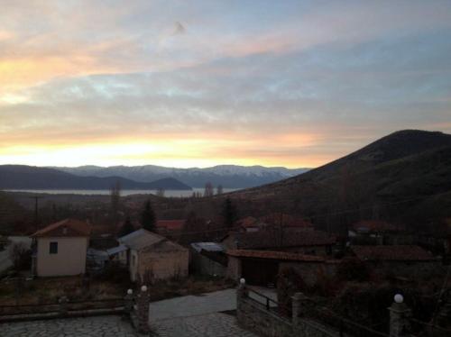 a view of a town with the sunset in the background at Varnous Hotel in Agios Germanos