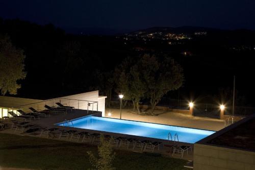 a swimming pool at night with chairs around it at Mas Ses Vinyes - Adults Only in Begur