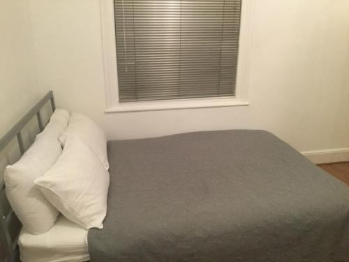 a bed with white pillows and a window in a room at OutRam 26 in Stockton-on-Tees