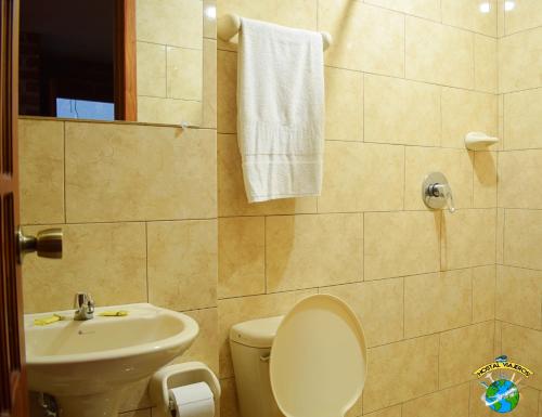 a bathroom with a toilet and a sink at Hostal Viajero's in Baños