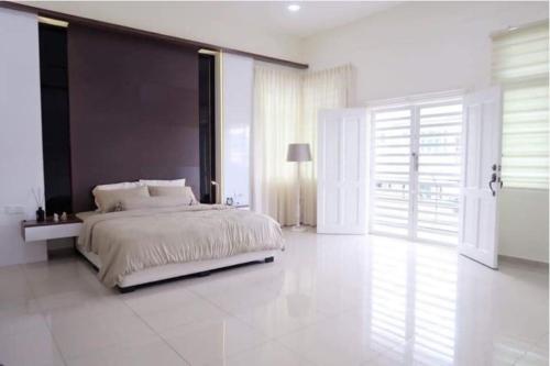 um quarto com uma cama grande e uma cabeceira preta em Malacca Homestay - 2 Storey Semi-D em Malaca