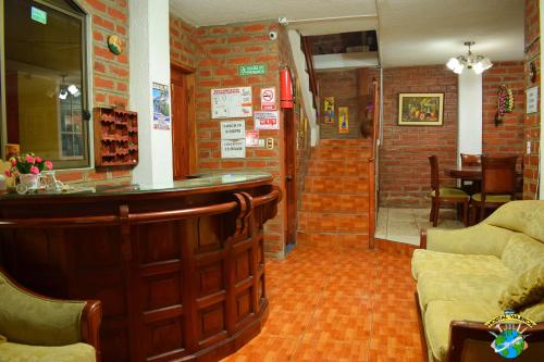 a bar in a restaurant with a brick wall at Hostal Viajero's in Baños