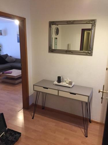 a table in a room with a mirror on the wall at Apartment Simone in Lörrach