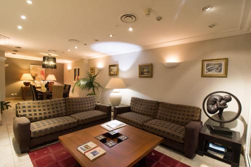 a living room with a couch and a table at Le Petit Prince in Sainte-Maxime