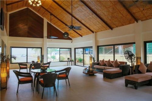a living room with a table and chairs at Paradise Garden Hotel and Convention Center Boracay Powered by ASTON in Boracay