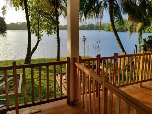 a view from the porch of a house overlooking the water at Koggala Lake view P&J Villa in Koggala