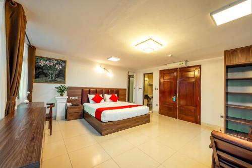 a bedroom with a bed and a desk in it at Westlake Tay Ho Hotel 696 Lạc Long Quân in Hanoi