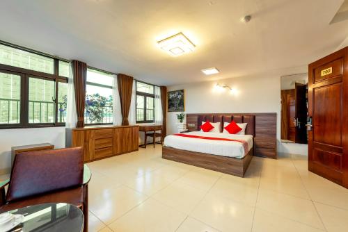 a bedroom with a bed with red pillows on it at Westlake Tay Ho Hotel 696 Lạc Long Quân in Hanoi