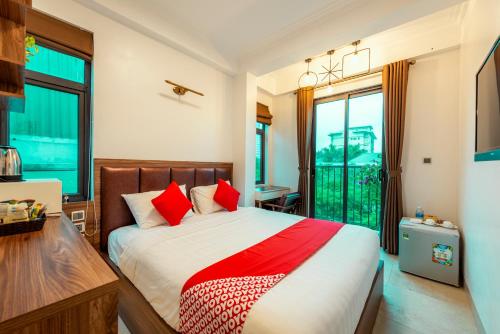 a bedroom with a large bed with red pillows at Westlake Tay Ho Hotel 696 Lạc Long Quân in Hanoi