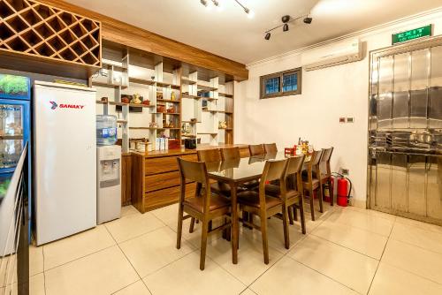 a kitchen with a table and chairs and a refrigerator at Westlake Tay Ho Hotel 696 Lạc Long Quân in Hanoi