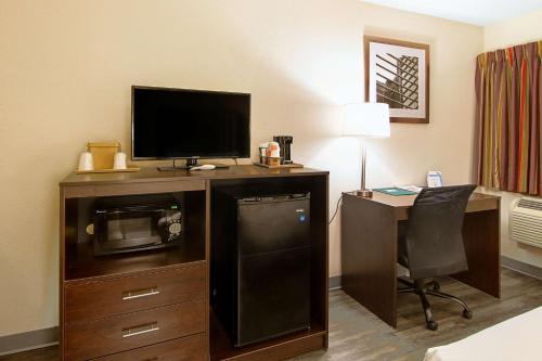 a hotel room with a desk with a television and a computer at Quality Inn Plainfield I-395 in Plainfield