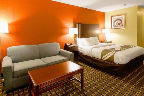 a hotel room with a bed and a couch at Quality Inn Plainfield I-395 in Plainfield