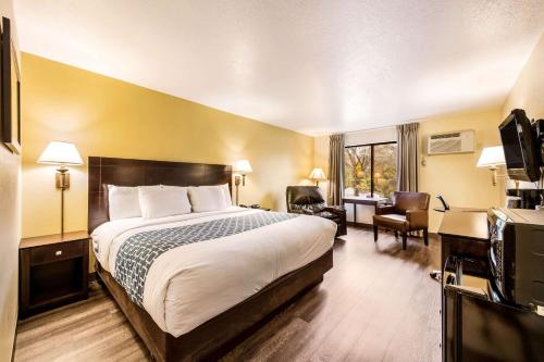 a hotel room with a bed and a desk at Econo Lodge Mayo Clinic Area in Rochester