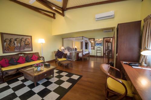 a living room with a couch and a table at Bagan Thiripyitsaya Sanctuary Resort in Bagan