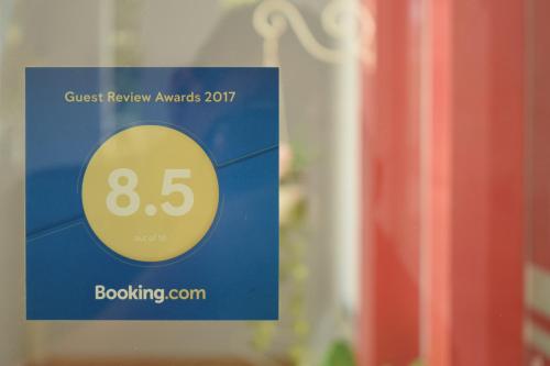 a blue and yellow sign with the number eightyfive at Jambura Inn in Gorontalo