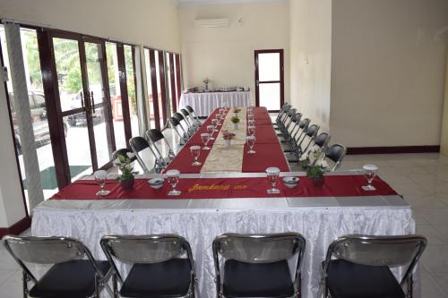 a long table in a room with chairs at Jambura Inn in Gorontalo