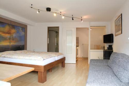 a bedroom with a bed and a couch at Artist Apartments & Hotel Garni in Zermatt