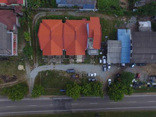 an aerial view of a house with cars on the street at Homestay Tok Ma 1 Alur Tuman Marang in Marang