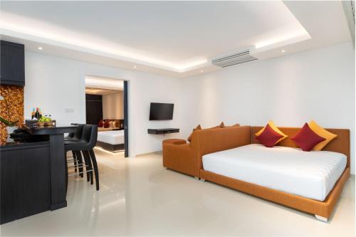 a living room with a couch and a dining room at Downtown Villas in Seminyak