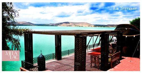a balcony with a view of the ocean and mountains at Rive Du Lac in Lalla Takerkoust