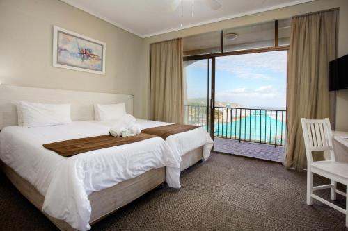 a bedroom with a large bed and a balcony at Marine Lodge in East London