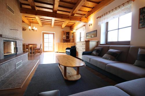 a living room with a couch and a table at Chata u Mikiho Krahule in Krahule