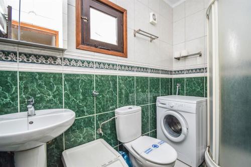 W łazience znajduje się toaleta, umywalka i pralka. w obiekcie El Capistrano Playa 301 w mieście Nerja