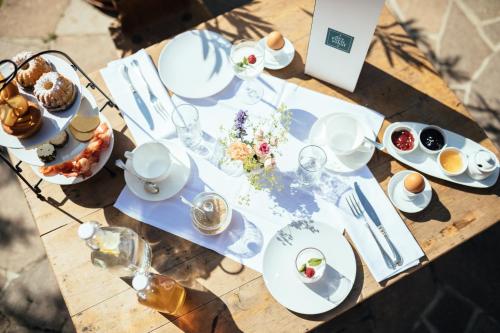
a table topped with plates of food and drinks at Garni-Hotel Der Forsterhof in Lagundo
