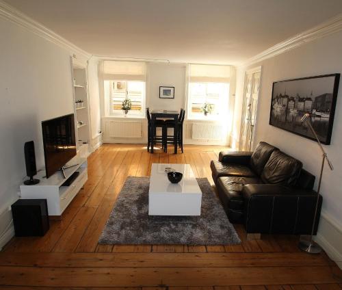 a living room with a couch and a table at Executive Living Old Town Unique in Stockholm