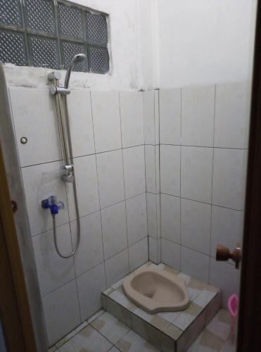 a bathroom with a toilet and a shower at Hazza syaria homestay in Garut
