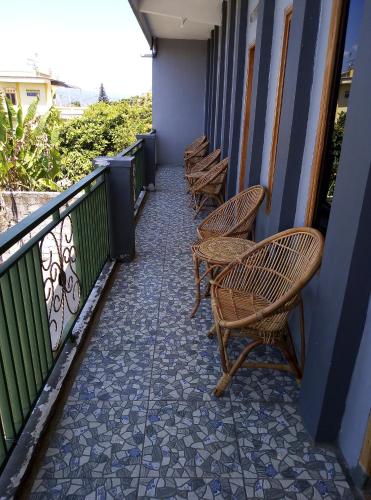 a row of chairs sitting on a balcony at Hazza syaria homestay in Garut