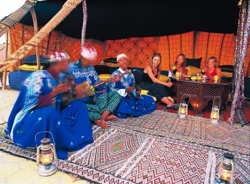 a group of people sitting on a couch at Rive Du Lac in Lalla Takerkoust