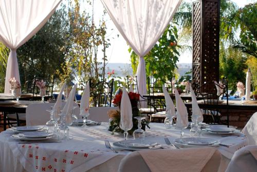 a table with white tablecloths and napkins on it at Rive Du Lac in Lalla Takerkoust