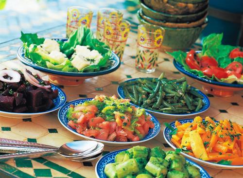 a table topped with bowls of different types of food at Rive Du Lac in Lalla Takerkoust