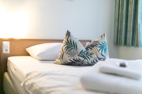 a bed in a hotel room with pillows on it at martas Hotel Allegra Berlin in Berlin