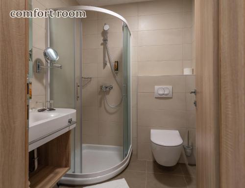 a bathroom with a shower and a toilet and a sink at Grand Hotel Rogaska in Rogaška Slatina