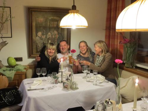 a group of people sitting around a table at Hotel Sonnblick in Wald am Arlberg