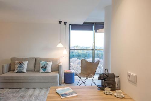 a living room with a couch and a table at Bordoy Alcudia Port Suites - Adults Only in Port d'Alcudia
