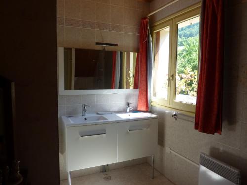 łazienka z białą umywalką i oknem w obiekcie Gîte des Gorges du Bruyant w mieście Saint-Nizier-du-Moucherotte